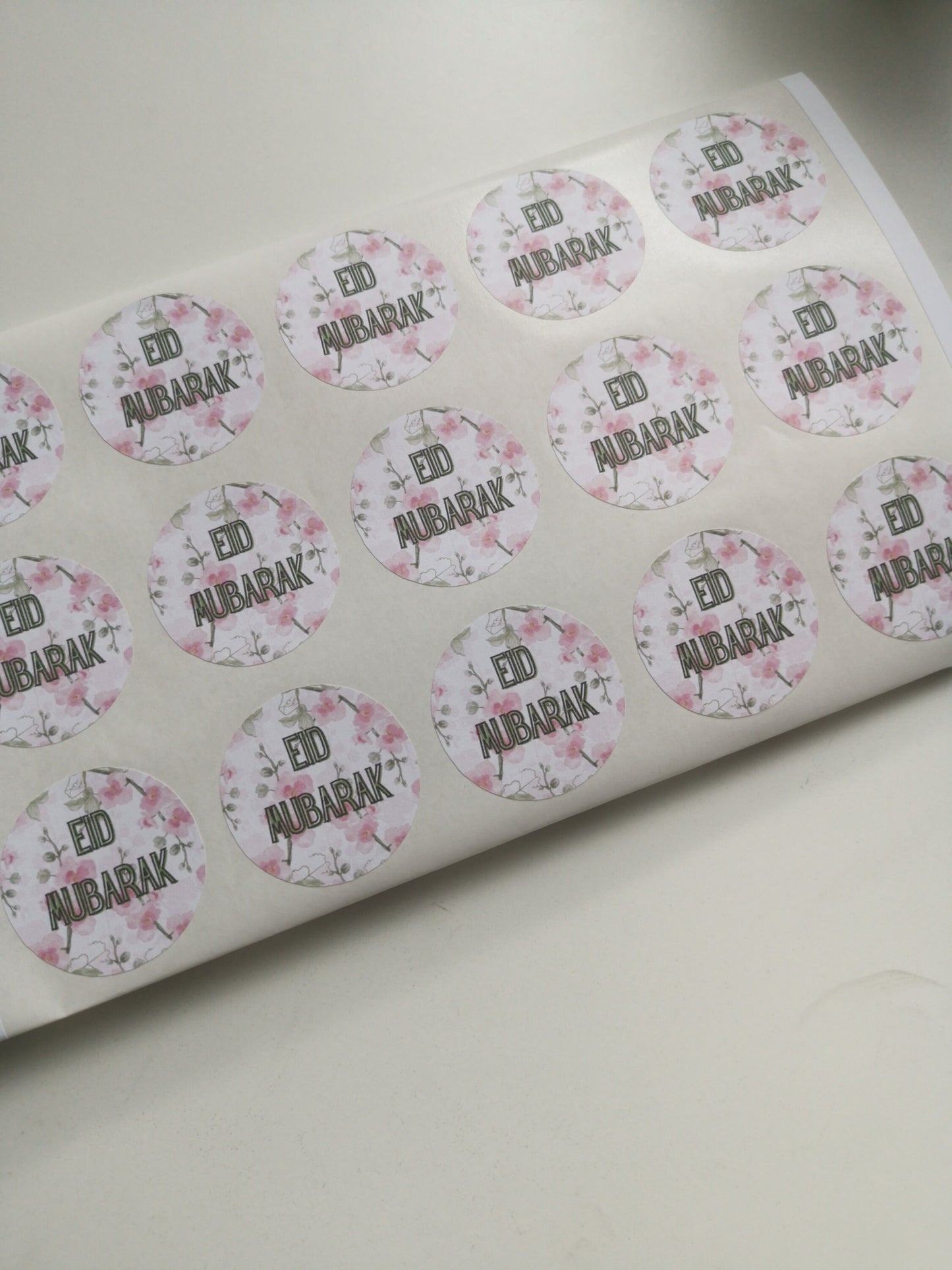 Floral pink Eid and Ramadan circle stickers, ideal for making sweet cones, and sticking to eid gifts